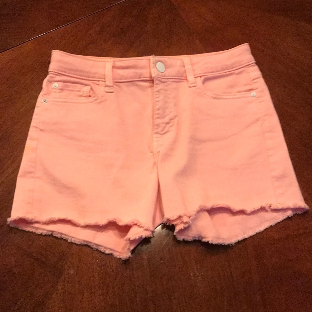 Pink jean shorts with frayed hem